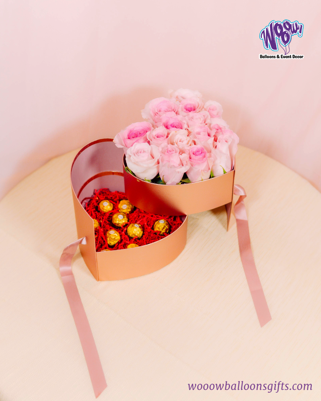 Rose Gold Heart Box with fresh pink roses and Ferrero Rocher chocolates in a luxurious rose gold heart-shaped box.