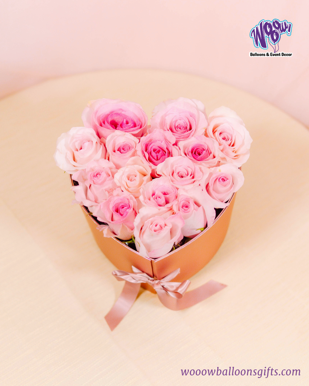 Rose Gold Heart Box with fresh pink roses and Ferrero Rocher chocolates in a luxurious rose gold heart-shaped box.