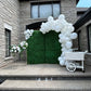 Wedding Balloon Decor featuring a greenery backdrop, organic balloon garland, and floral pedestals with dessert cart.