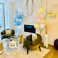 Decorated living room with balloons and furniture, featuring a baby new born balloons and bubble with delivery in Toronto.