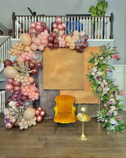 Custom Balloon Garland Toronto – luxury rose gold balloon installation with floral arch backdrop for elegant events by Wooow Balloons