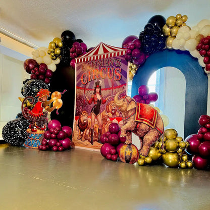Personalized circus birthday balloon backdrop with black, magenta and gold garlands and animal props in Toronto.