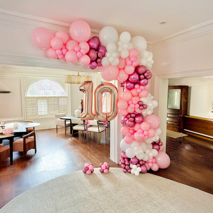 Luxury birthday balloon garland setup in a Toronto home with organic balloons and milestone number balloons