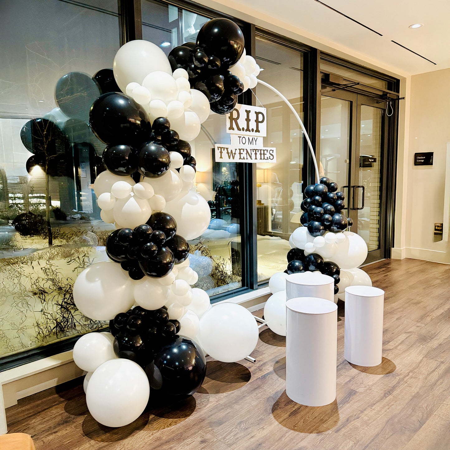 Black and white 30th birthday decor Toronto with modern circular backdrop and organic balloon arch