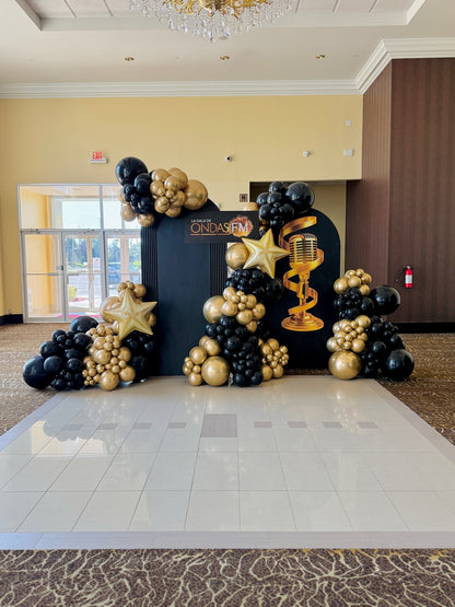 Luxury black and gold gala balloon installation with custom backdrop by Wooow Balloons Toronto.