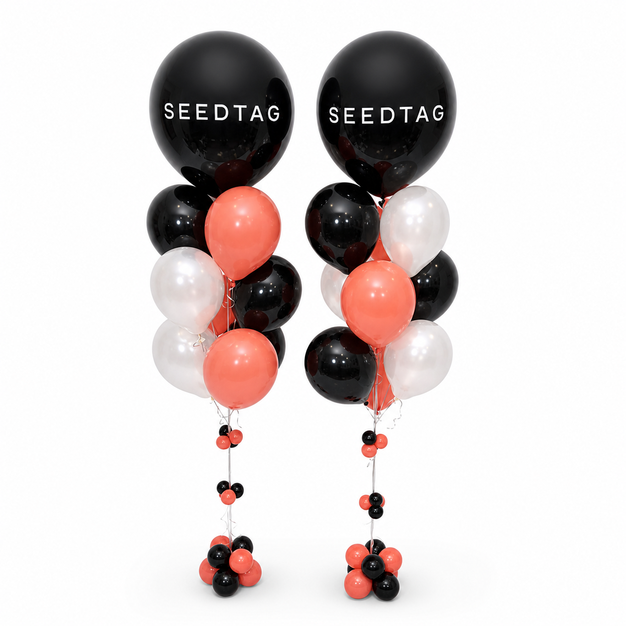 Custom branded balloon columns in black, coral and white for corporate event decor in Toronto by Wooow Balloons