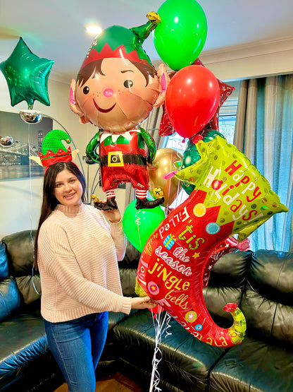 Festive Christmas balloon bouquet with elf foil balloon and holiday stocking design, handcrafted for same-day Christmas balloon delivery in Toronto.