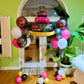 Elegant pink and black birthday balloon display Toronto – Luxury birthday balloon setup with cake-shaped foil balloon by Wooow Balloons Toronto