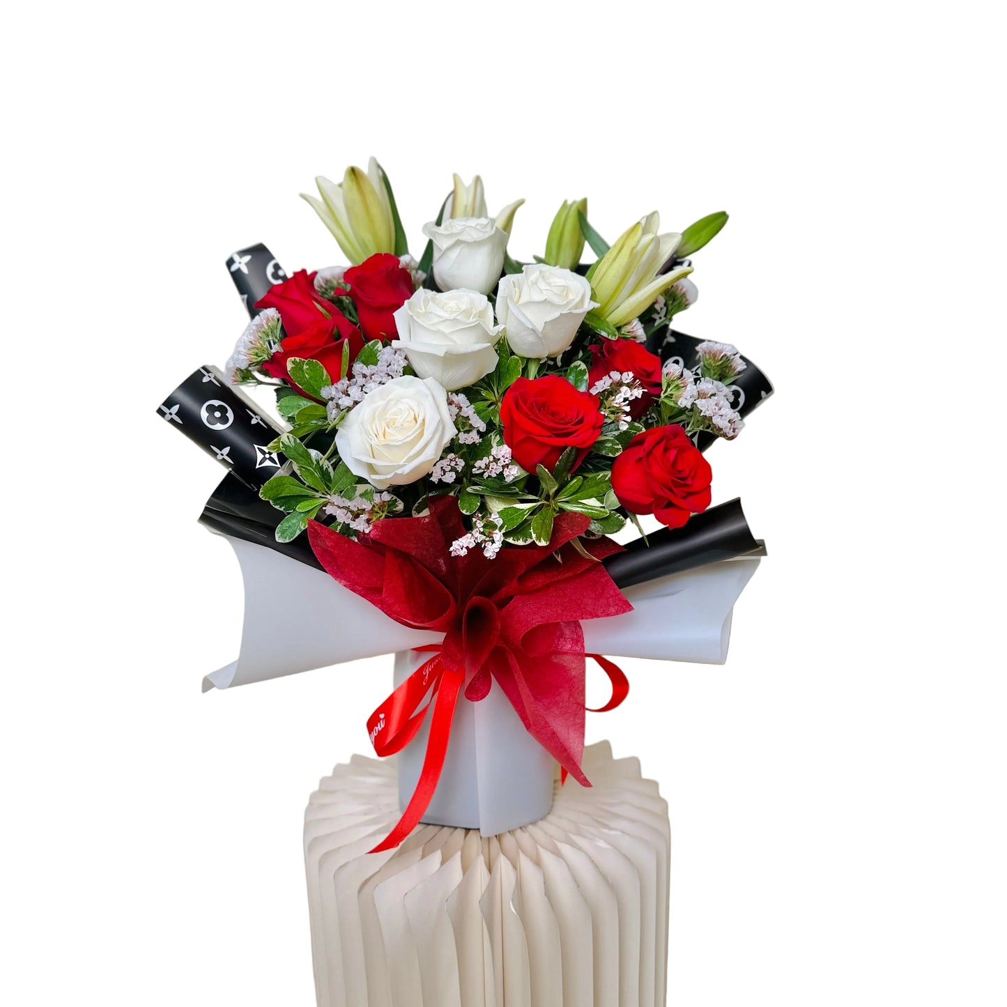 Fresh Mother’s Day bouquet with roses and lilies wrapped in luxury floral paper
