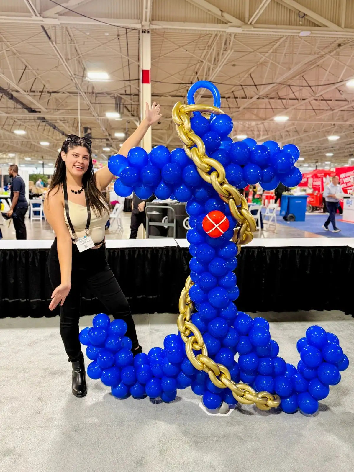 Giant blue anchor balloon sculpture with a gold chain by Wooow Balloons for a corporate event in Toronto.