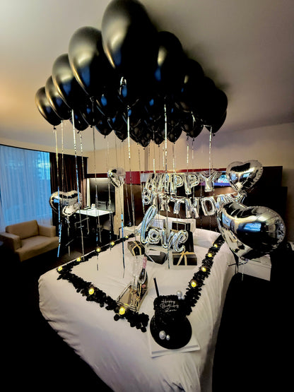 Glam hotel room balloon setup for a luxury birthday celebration