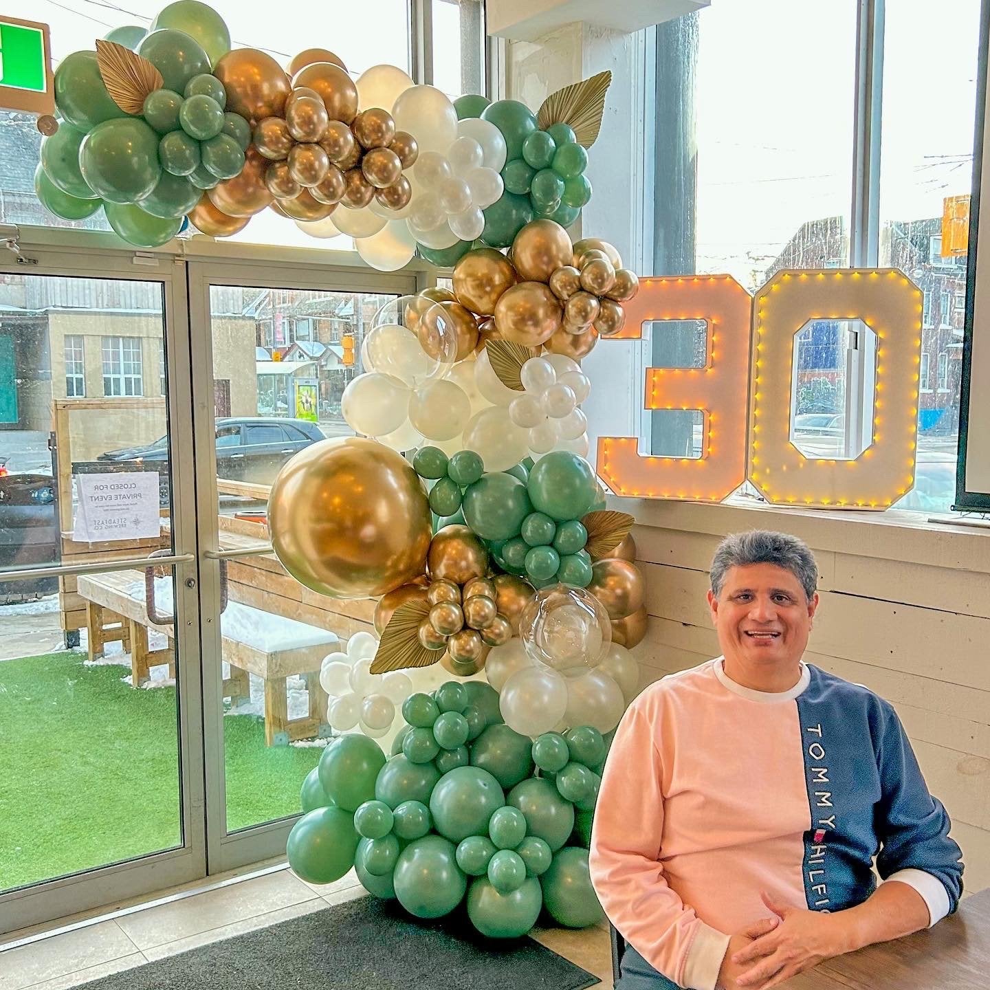 Green and gold balloon arch for 30th birthday celebration Toronto