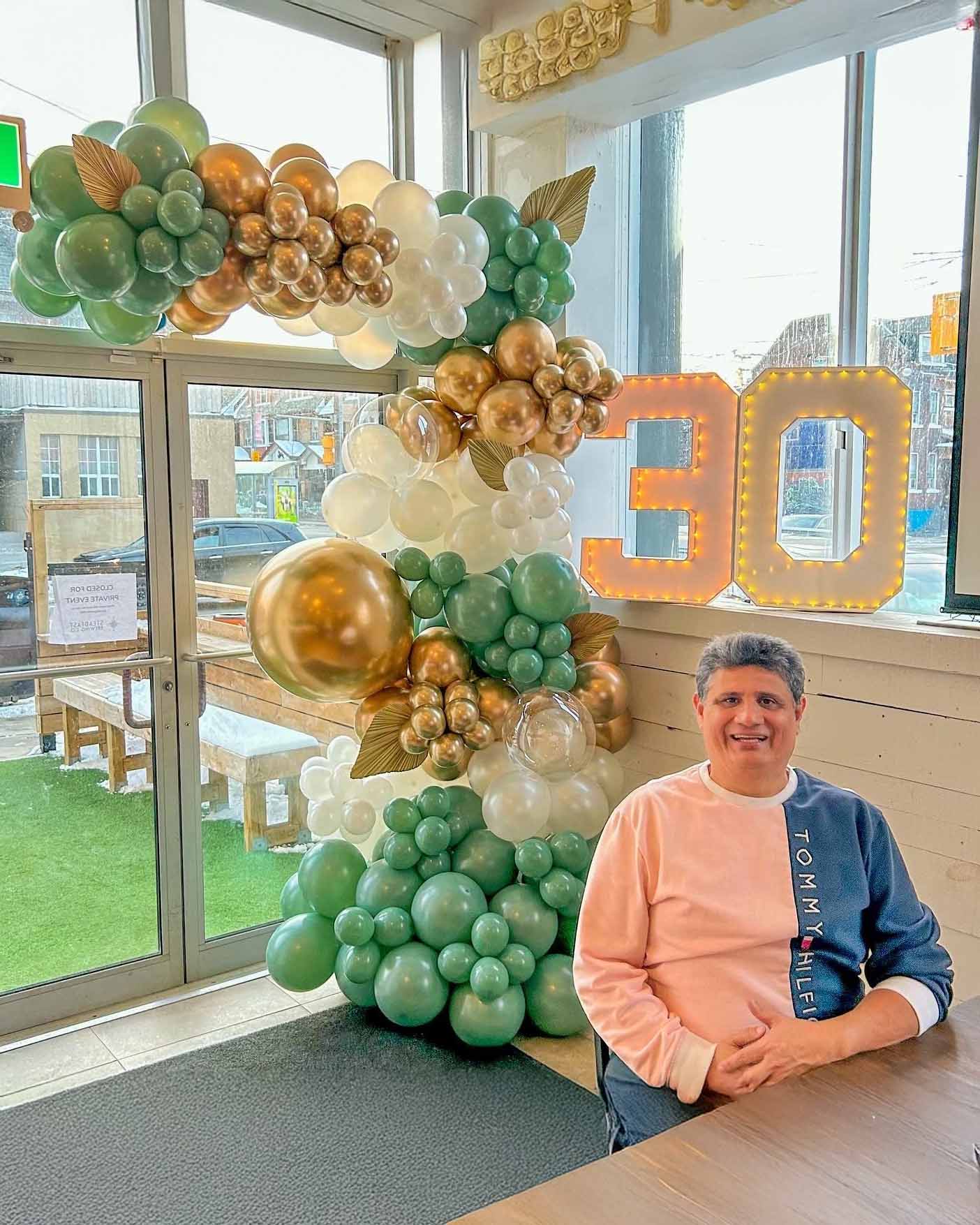 Custom Balloon Garland Toronto – green, gold, and white luxury balloon arch with number 30 lights for birthday celebration by Wooow Balloons