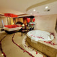 Heart balloon decor and rose petals by the jacuzzi – romantic room design in Toronto