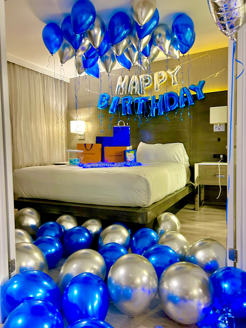 Blue and silver hotel birthday balloon decor with helium balloons, floor balloons, banner and number stands in Toronto