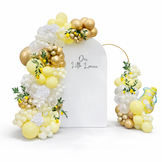 Elegant lemon themed baby shower balloon backdrop with organic balloon garland in yellow, white and gold, custom event decor Toronto, luxury balloon installation