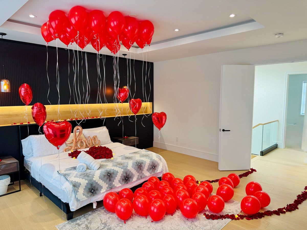 LOVE balloon sign with red balloons and rose petals for romantic room decor in Toronto