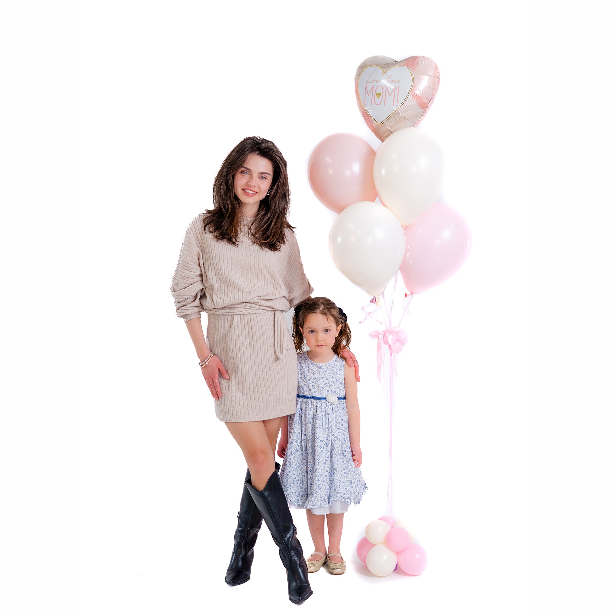 Mother holding flowers beside elegant Mother’s Day balloons in Toronto