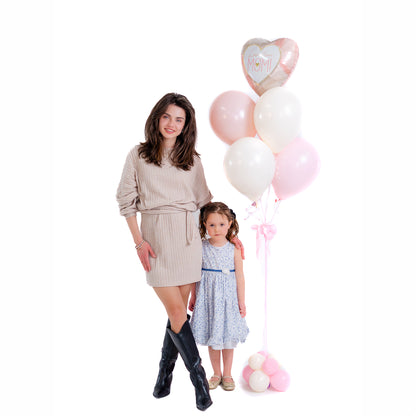 Mother holding flowers beside elegant Mother’s Day balloons in Toronto