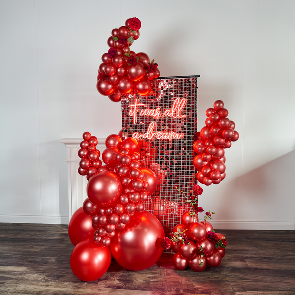 Luxury Valentine’s Day balloons in Toronto featuring a red shimmer wall backdrop and premium balloon installation