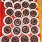 Chocolate donuts with pink sprinkles on a red tray