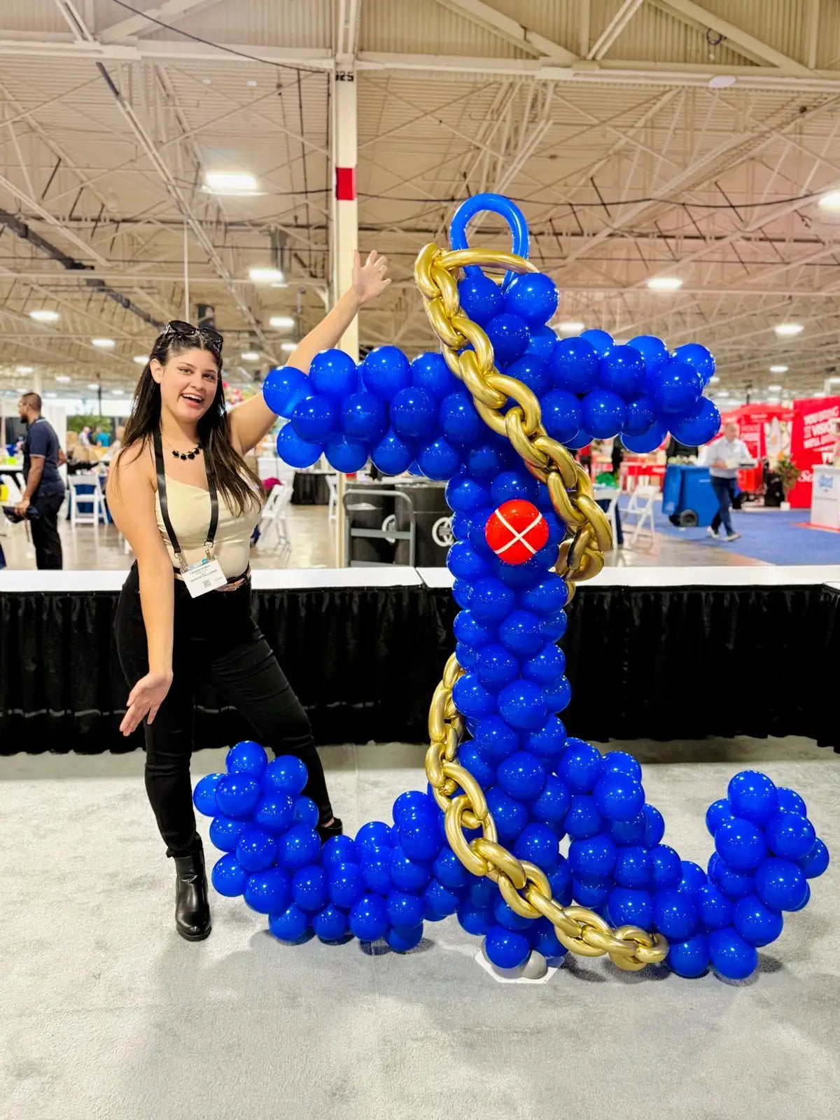 Large royal blue balloon anchor with a metallic gold chain displayed at a Toronto trade show by Wooow Balloons.