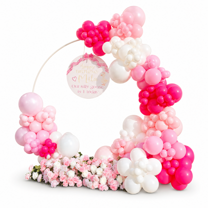Luxury pink and white baby girl balloon hoop with custom birthday sign, floral styling, and organic balloons for a first birthday party in Toronto