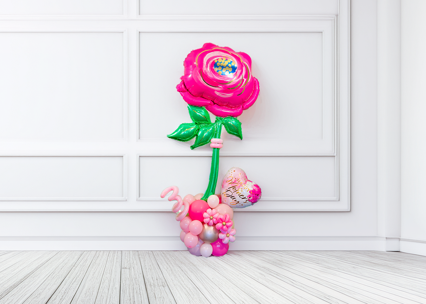 Giant pink flower balloon stand with heart balloon and latex balloons, helium-filled top and air-filled base