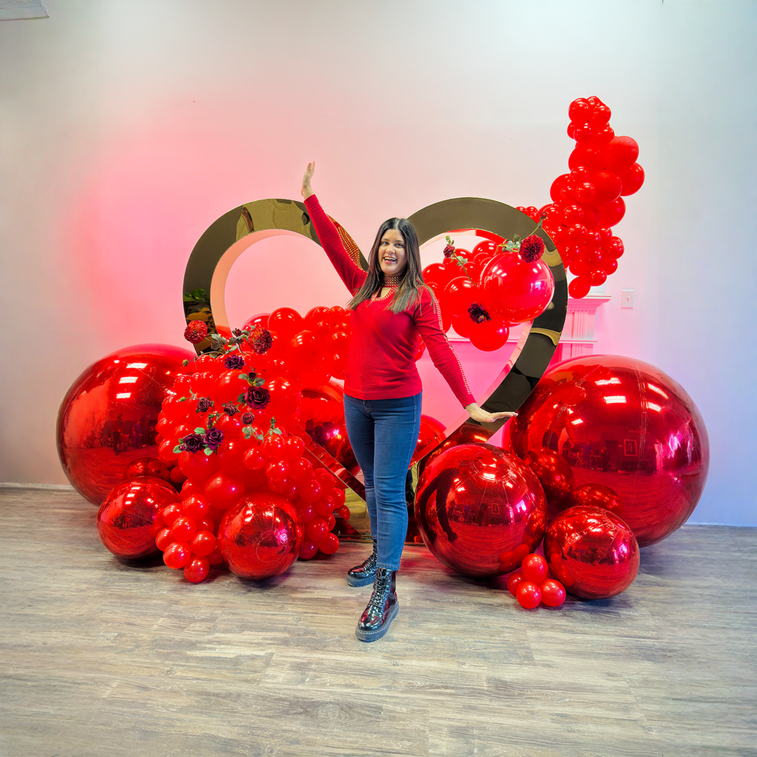 Full luxury proposal balloon decoration in Toronto with gold heart backdrop, red balloons, florals, and mirror ball accents