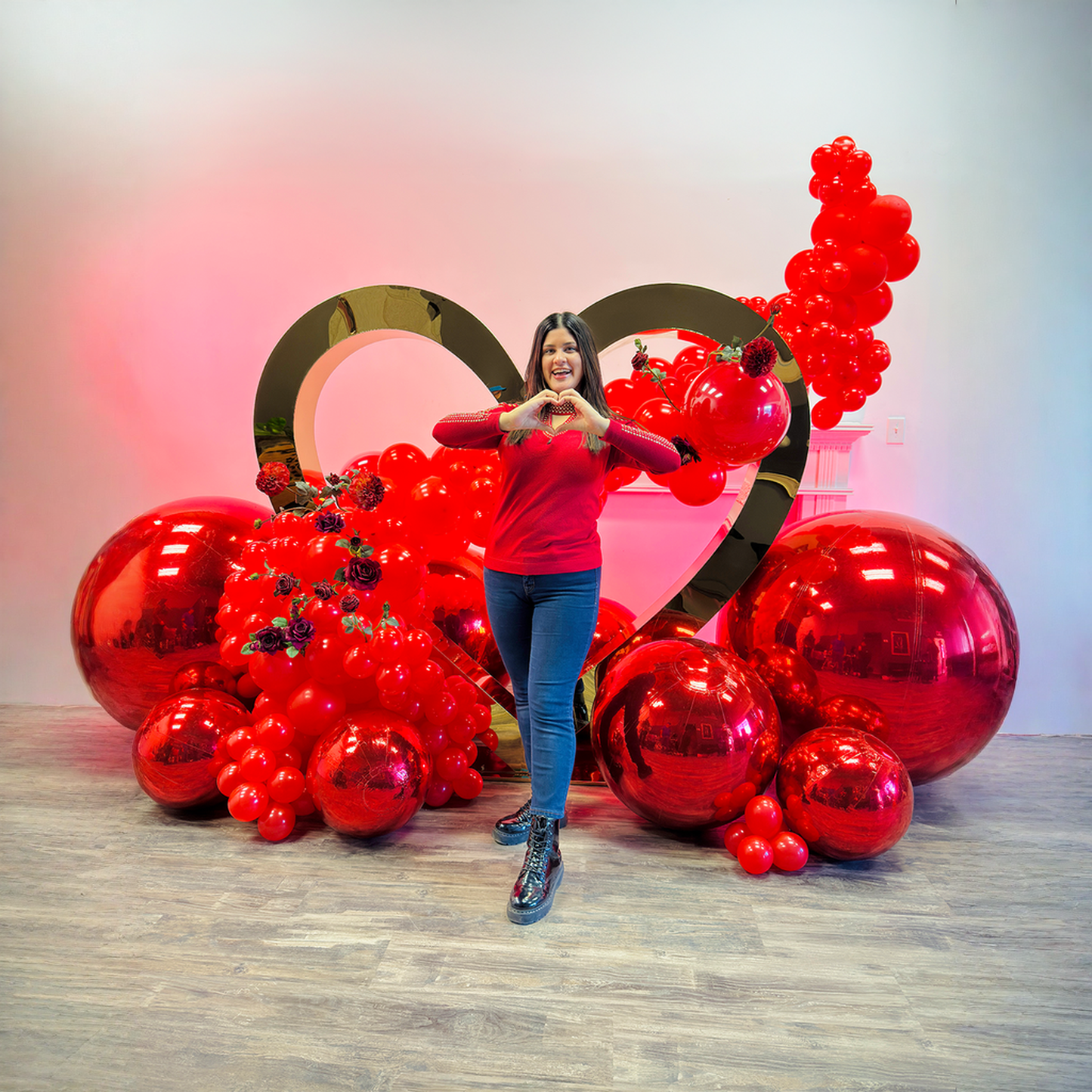 Proposal balloon decoration Toronto featuring a luxury gold heart backdrop with red balloon garland and mirror balls