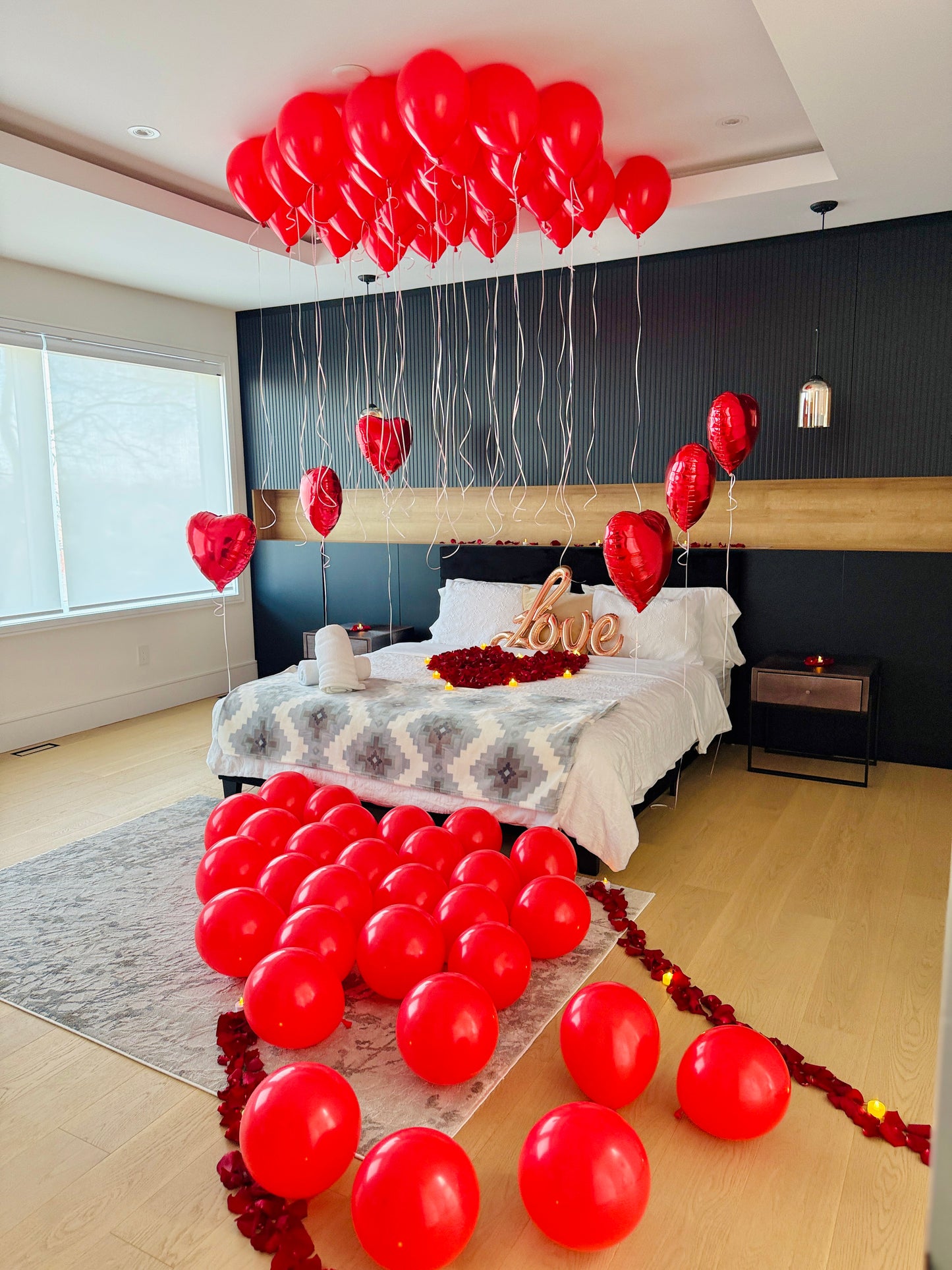 Proposal room decoration with red helium balloons heart details and romantic styling in Toronto