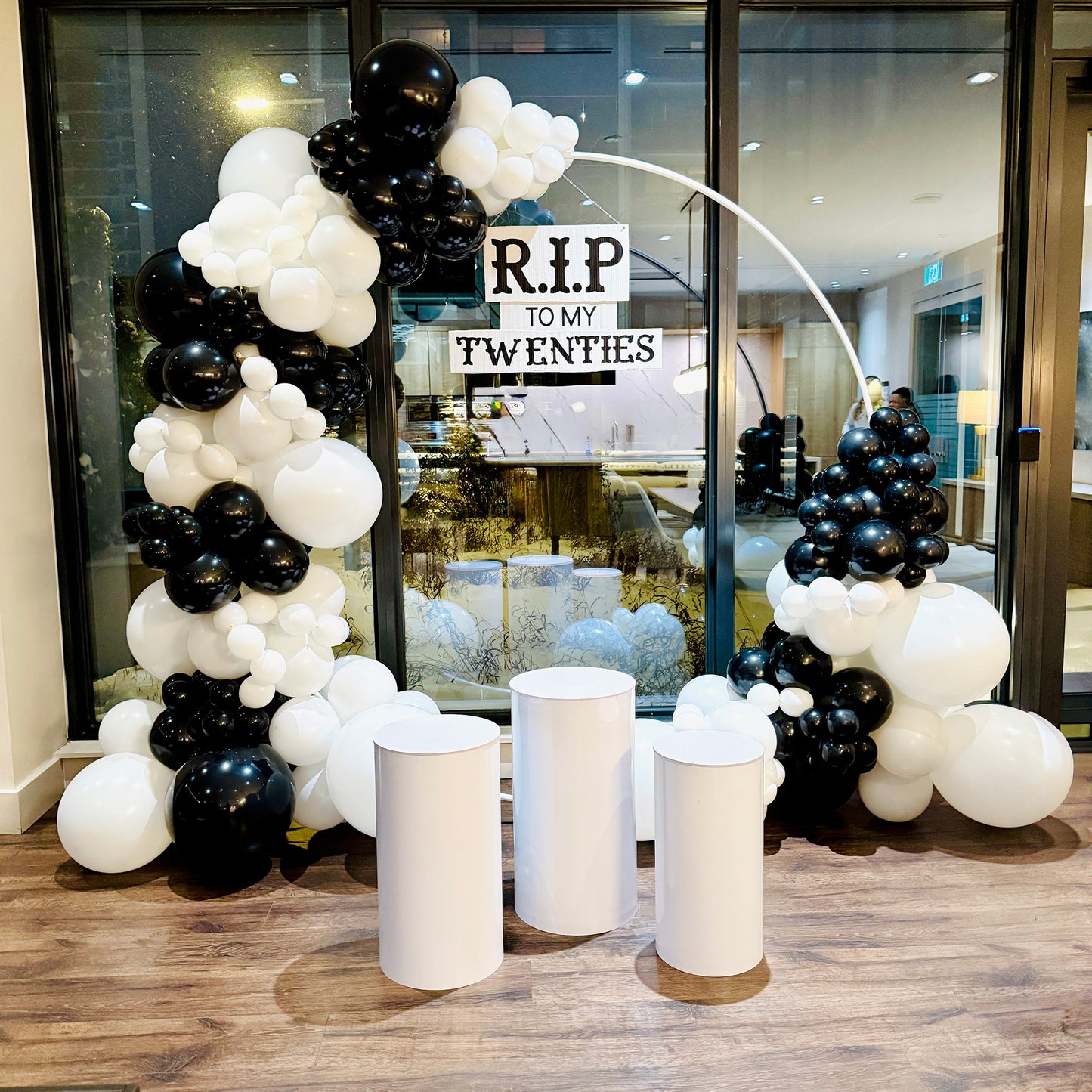 Luxury 30th birthday balloon arch Toronto with RIP to My Twenties sign in black and white theme