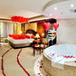Romantic bedroom setup with floating red balloons and “Love” sign – Valentine’s Day decor in Toronto by Wooow Balloons.