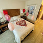 Valentine’s hotel room decor with fresh petals and heart-shaped balloons – Wooow Balloons Toronto.