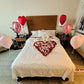 Romantic hotel room setup with heart-shaped rose petals and heart balloons in Toronto by Wooow Balloons