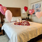 Romantic bed decoration with heart balloons, petals, and LED candles – perfect for anniversaries in Toronto