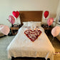 Elegant romantic bed decoration with red and pink heart balloons for couples in Toronto