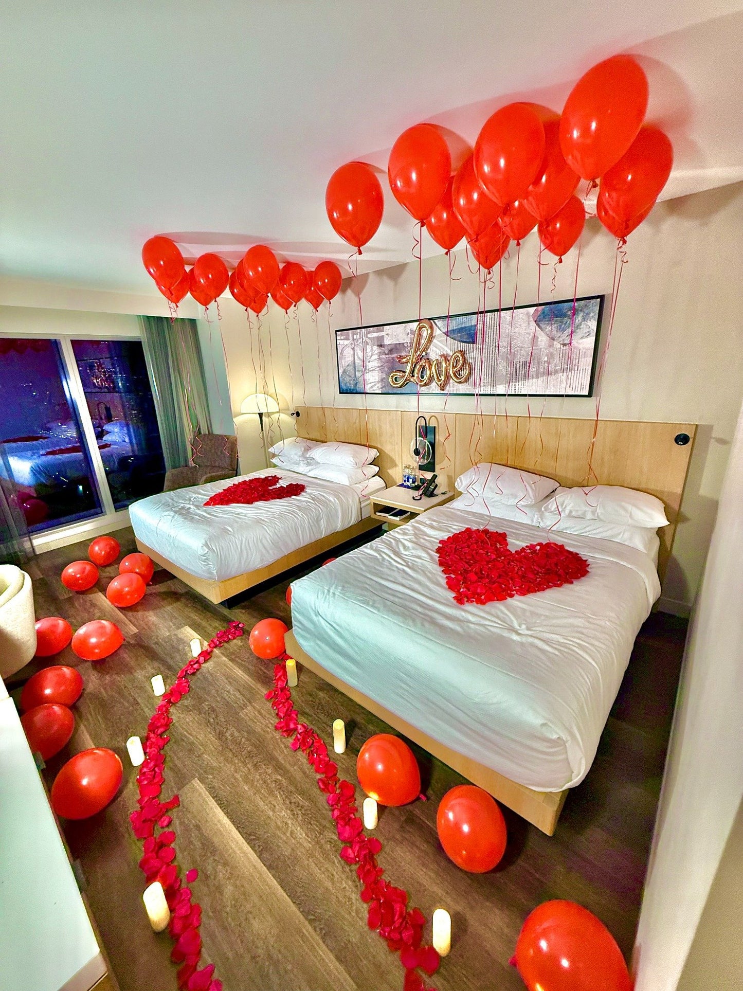 Romantic Hotel Room Balloon Decor Toronto with ceiling balloons, roses, and LED candles ready for a surprise reveal.