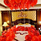 Hotel room decorated for a romantic surprise with heart balloons and candles in Toronto.