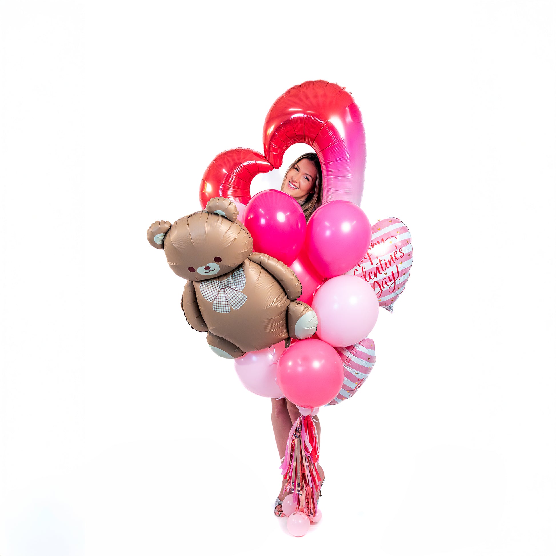Romantic teddy balloon bouquet Toronto with Valentine balloons, heart foil balloons, and decorative tassel tail.