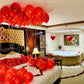 Rose petals pathway and red balloons leading to a luxury bed – romantic experience by Wooow Balloons Toronto