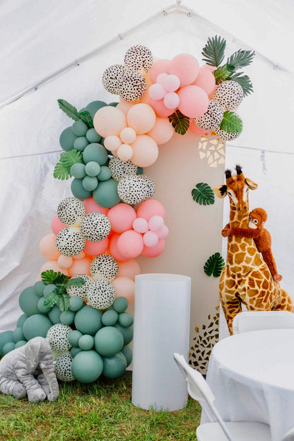 Cute Wild Style Balloon Decor with biodegradable balloon garlands, jungle animal figures, and a customizable backdrop.

