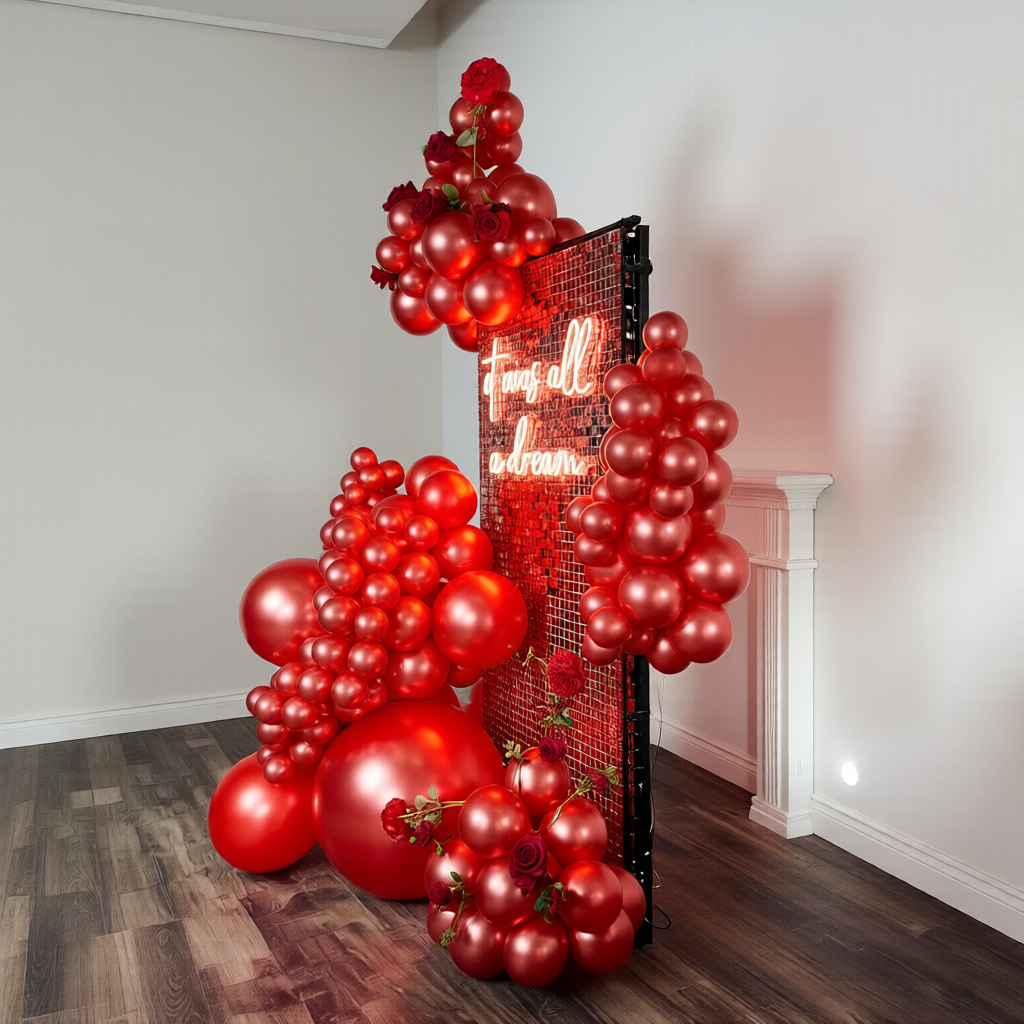 Close-up of Saint Valentines balloons in Toronto with glossy red balloons and shimmer wall backdrop.