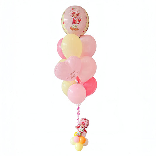 Strawberry Shortcake birthday balloon bouquet in Toronto with pink and yellow helium balloons, pink hearts and a character accent by Wooow Balloons