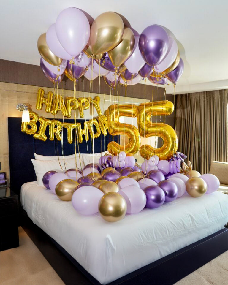 Surprise Birthday Hotel Decor Toronto – elegant purple and gold balloon setup with ceiling balloons, number balloons and bed decoration by Wooow Balloons
