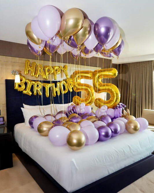 Surprise Birthday Hotel Decor Toronto – elegant purple and gold balloon setup with ceiling balloons, number balloons and bed decoration by Wooow Balloons