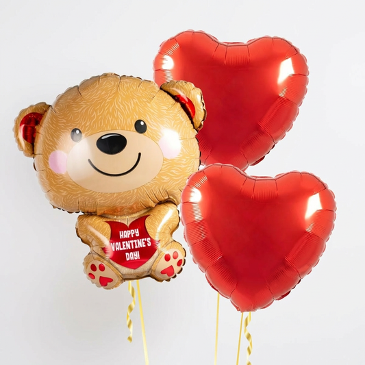 Teddy bear balloon bouquet Toronto with a teddy supershape balloon and two red heart helium balloons for Valentine’s Day