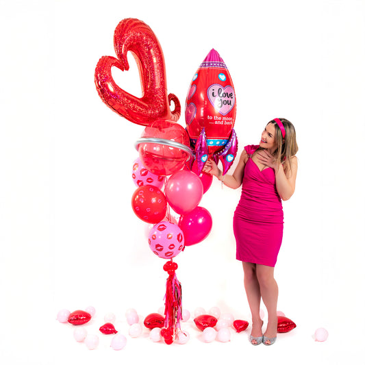 To The Moon & Back Valentine Balloon Bouquet (Toronto) with red open-heart foil balloon, rocket balloon, mixed latex balloons and tassel weight.