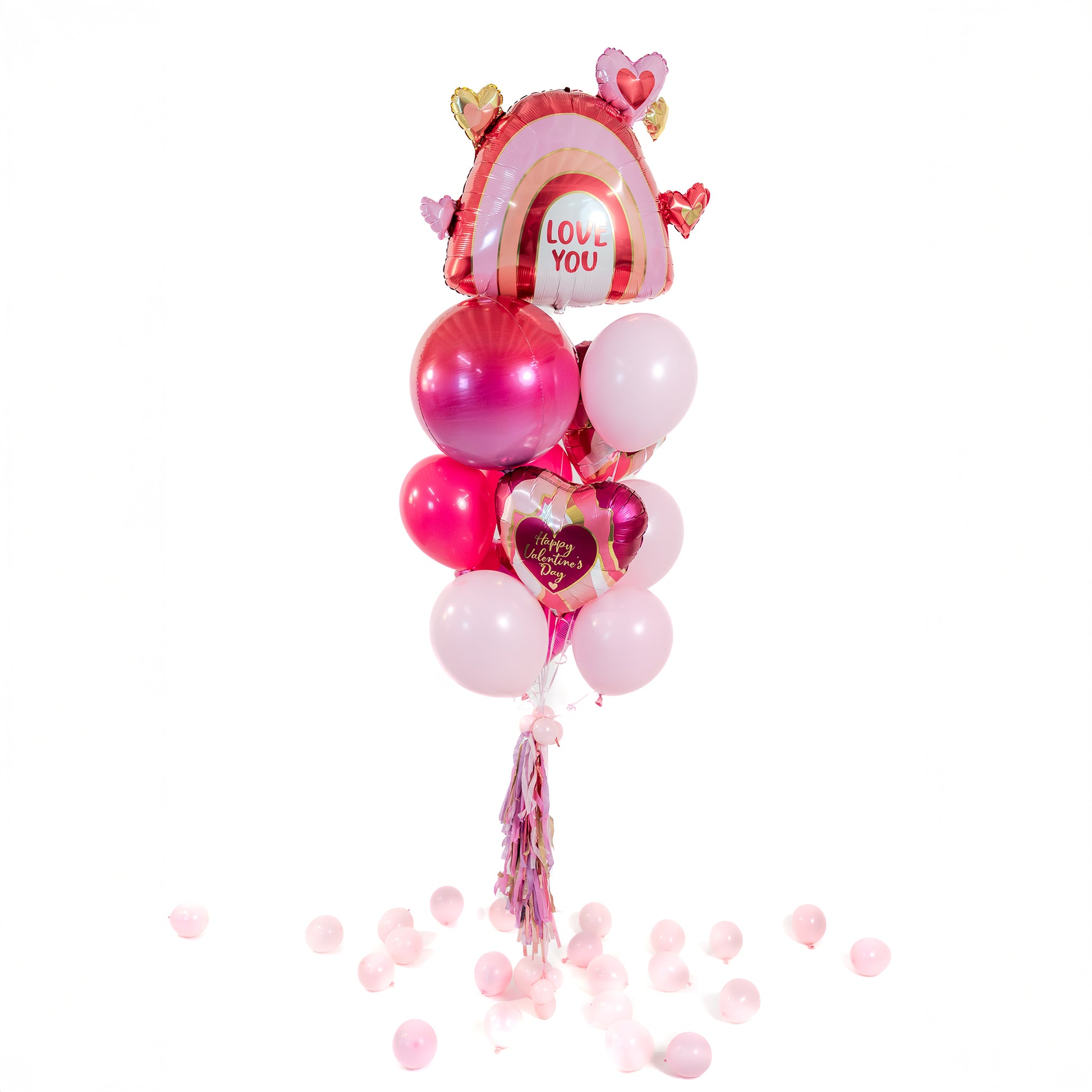 Valentine balloon bouquet in Toronto featuring a rainbow heart foil balloon, heart-shaped foils and a mix of pink latex balloons.