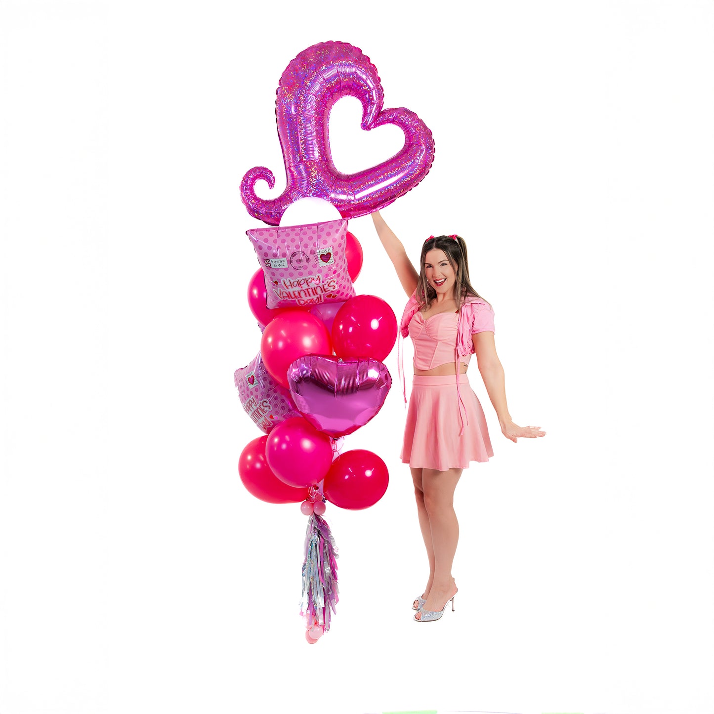 Woman posing with Valentines balloons in Toronto, featuring a Love Mailbox balloon bouquet and heart supershape.